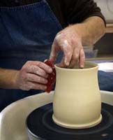 making mug on potter's wheel